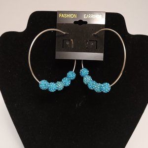 Light blue beads on silver hoop earrings. Middle size hoops